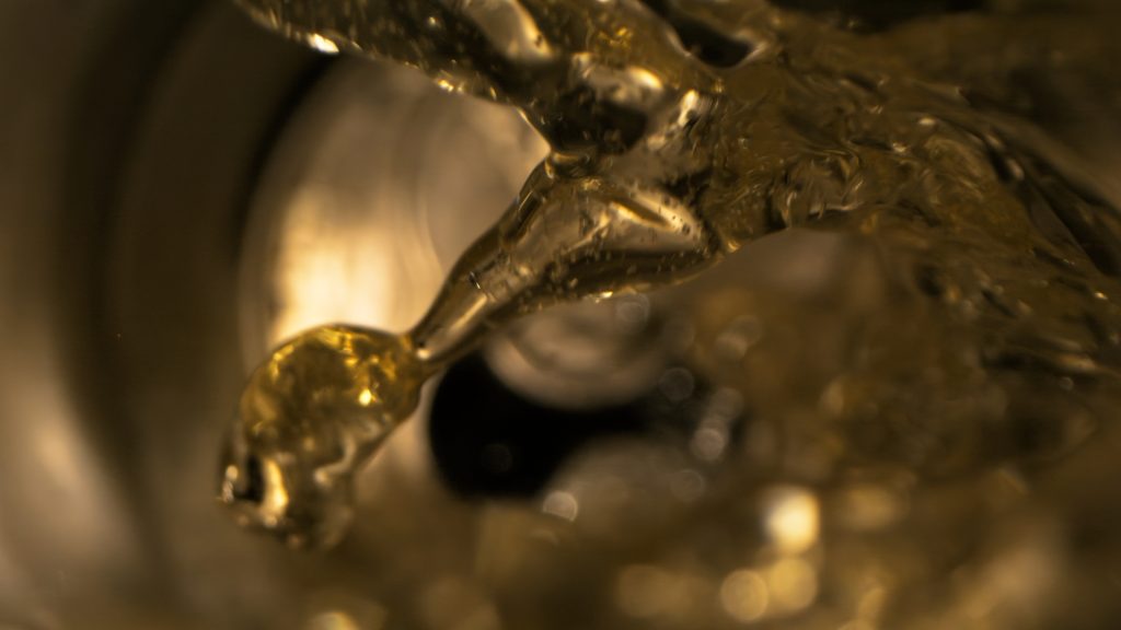 Macro splash of golden lager liquid captured with high-speed cinematography for a tabletop beer advertising campaign case study.