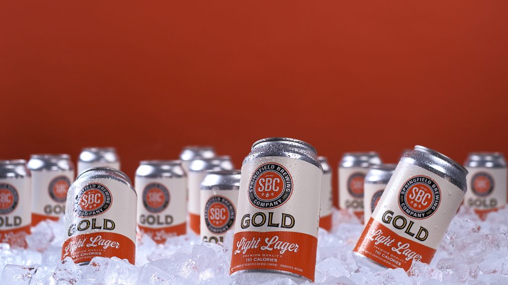 Gold Light Lager cans surrounded by ice for a tabletop beer advertising campaign case study.