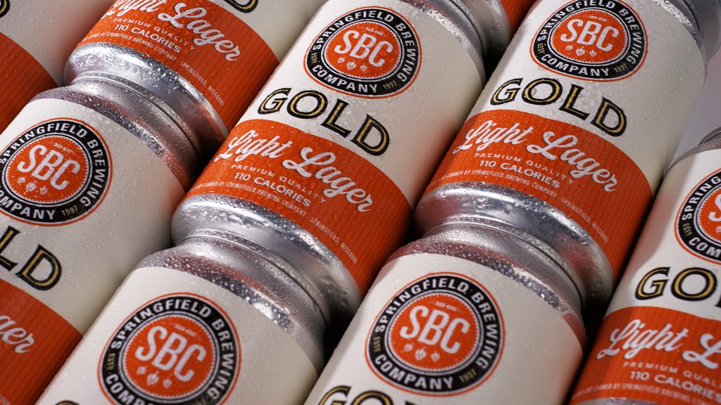 Pattern of Gold Light Lager cans arranged for a tabletop beer advertising campaign case study.